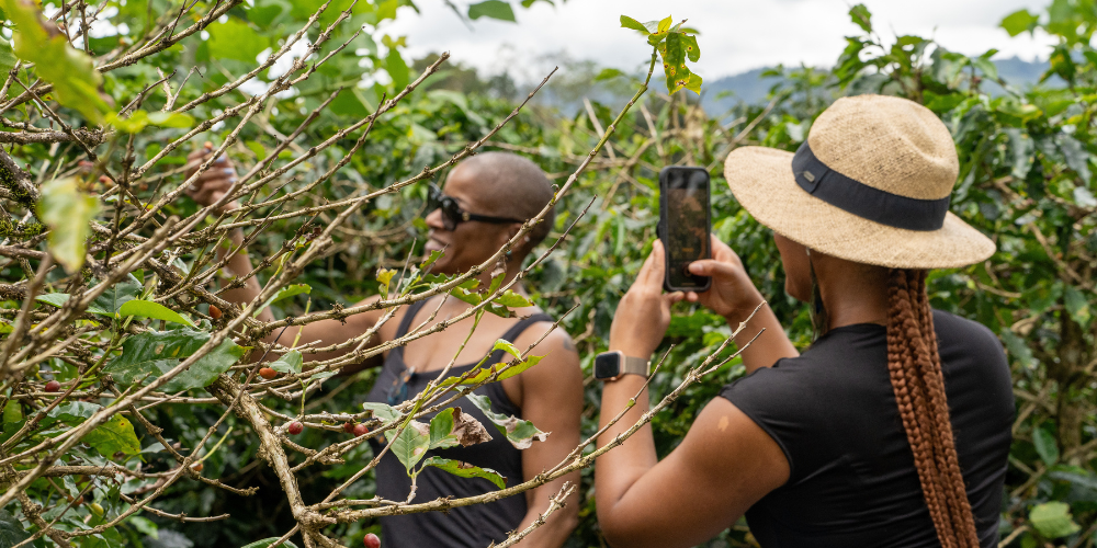A woman takes a photo of another outside in Costa Rica