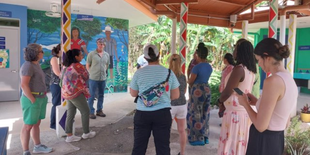 People gather under cover at a health facility in Costa Rica