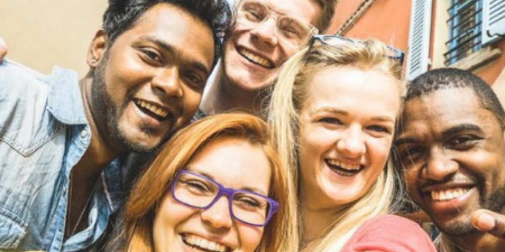 Five students pose for a selfie