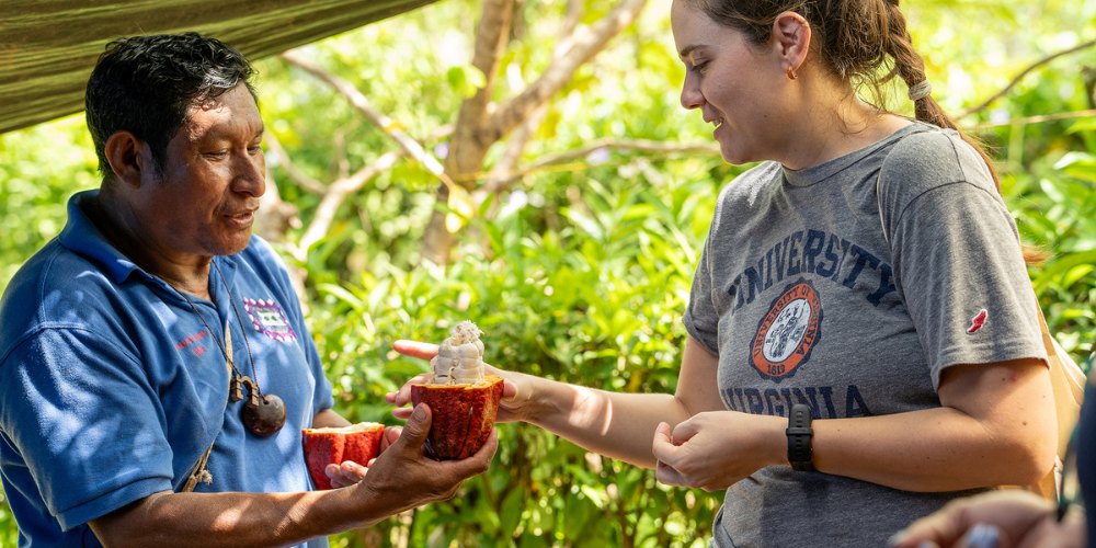 Megan Dunning, PhD, associate professor of medicine, University of Maryland School of Medicine, receives a cacao pod from Antonio Palacios