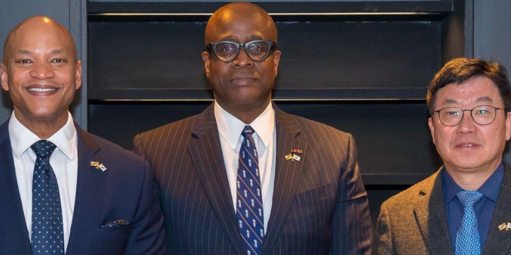 Gov. Wes Moore, Dr. Roger Ward, and a Korean official pose for a photo