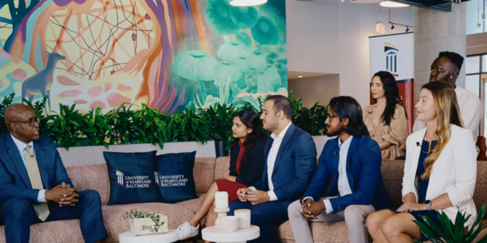 A group of graduating students gather for a discussion with Dr. Roger Ward