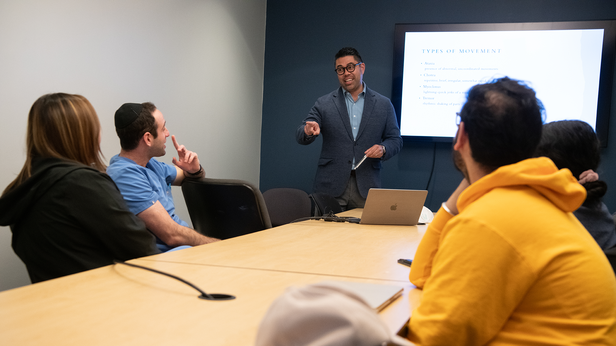 Glenn Canares, DDS, speaks with a group of students