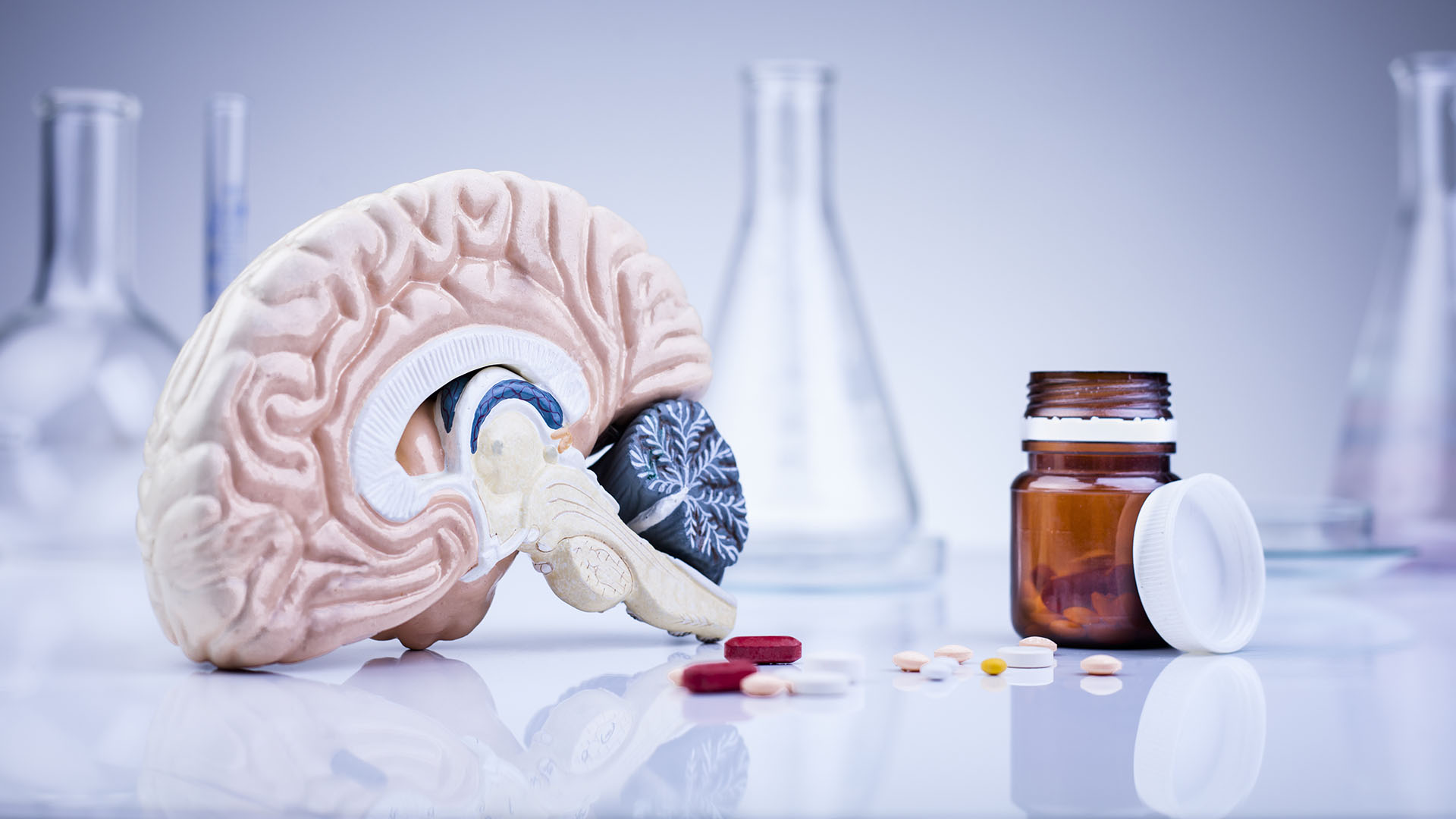 brain in a laboratory with scattered pills