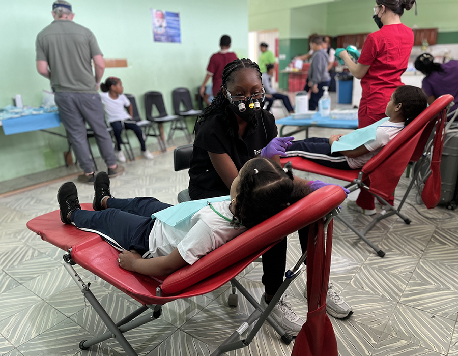 Dental students working on young patients in the Dominican Republic