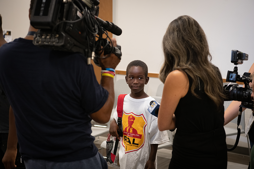 News crew talks with school child