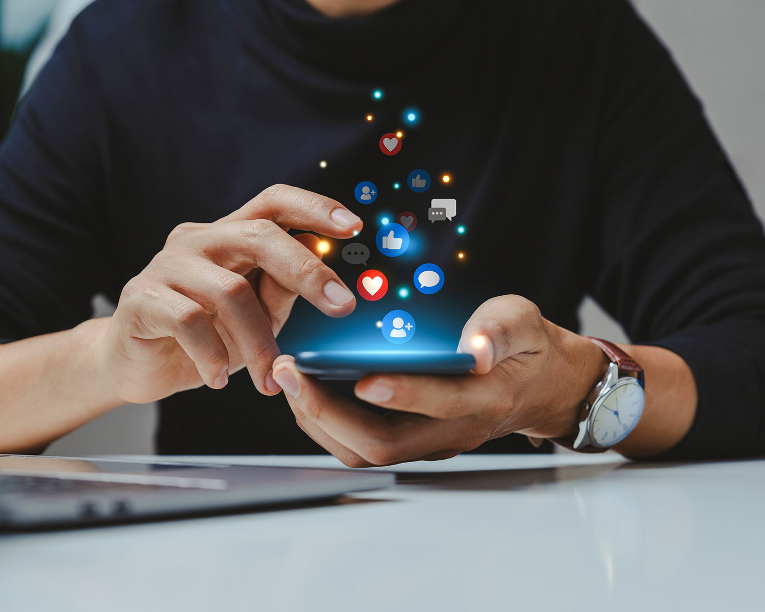 a mobile phone with social media icons floating out of it