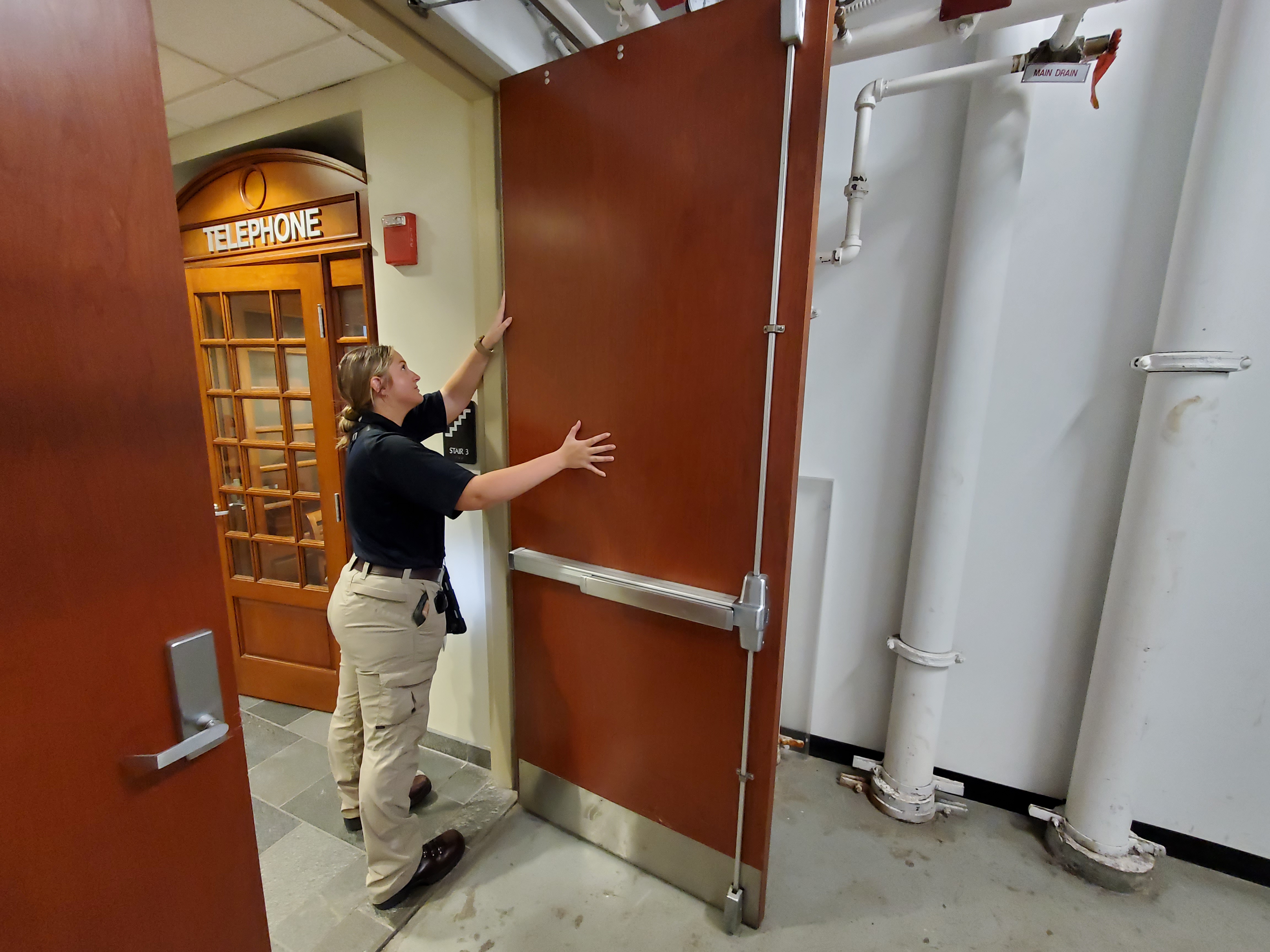 A person inspecting a door
