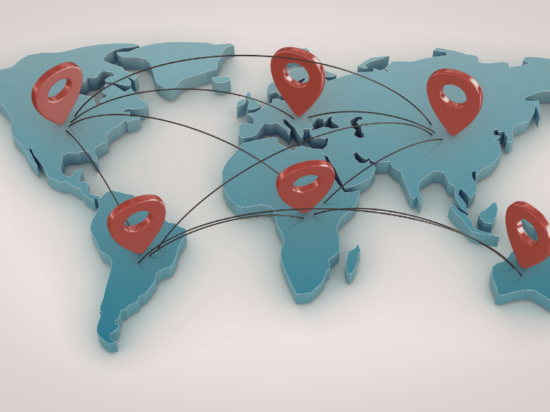 A global map with pins in it and lines connecting the continents