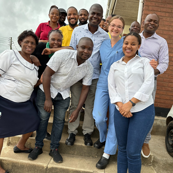 A student poses with colleagues and students she worked with in Malawi