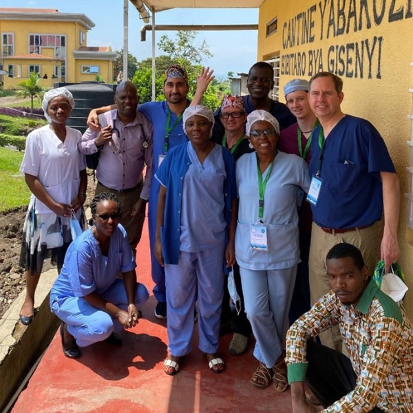 A group of doctors pose for a photo outside in Rwanda