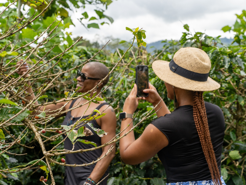 A woman takes a photo of another woman outside in Costa Rica