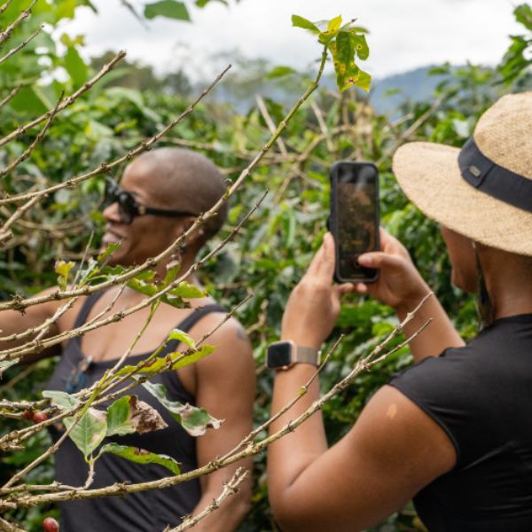 A woman takes a photo of another woman outside in Costa Rica