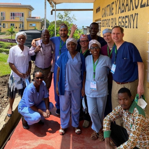 A group poses for a photo outside in Rwanda