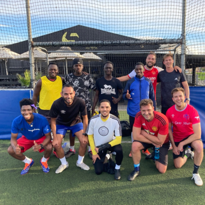 Guys in soccer gear pose for a photo in front of the goal