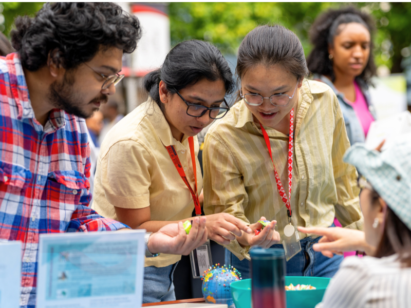 Students select candy from a bowl during Fall Involvement Fair