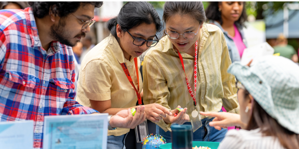Students select candy from a bowl during Fall Involvement Fair