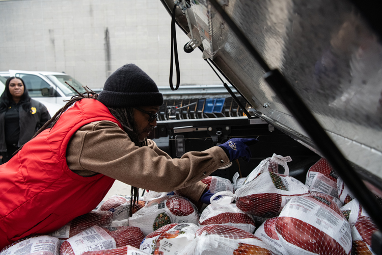Brian Sturdivant lends a hand loading turkeys for community distribution during the annual Season of Giving Thanksgiving Drive.