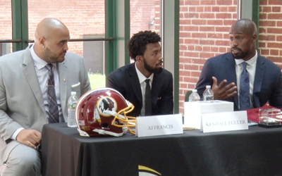 A.J. Francis, left, Kendall Fuller, and Vernon Davis, all members of the Washington Redskins, speak at an event held by the University of Maryland School of Dentistry to observe National Facial Protection Month.