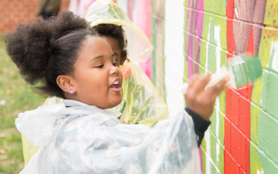 Kylie Adkins helps paint a mural at James McHenry Elementary/Middle School.