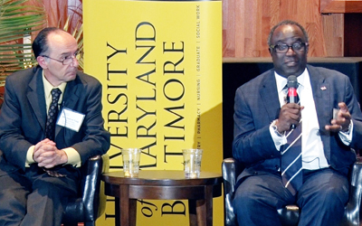 Andy Coop, PhD, professor and associate dean for academic affairs at the University of Maryland School of Pharmacy listens as Bankole A. Johnson, DSc, MD, FRCPsych, DFAPA, FACFEI, the Dr. Irving J. Taylor Professor at the University of Maryland School of Medicine, speaks on the panel of 