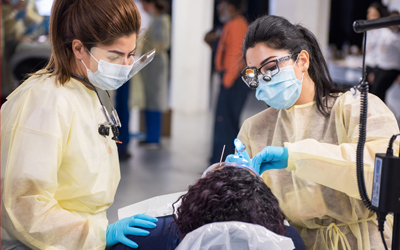 Students of the University of Maryland School of Dentistry treat a patient at the 2019 Mission of Mercy in Baltimore.