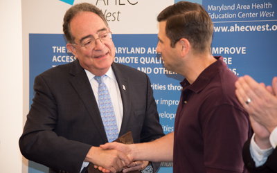 Dr. Perman receives award from Michael Motter, Psy.D., Chairman of the AHEC West Board of Directors