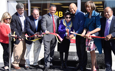 Cutting the ribbon to open UMB's new Community Engagement Center were (l-r) Director of Community Engagement Ashley Valis, Southwest Partnership Director Michael Seipp, UMB President Jay Perman, Del. Antonio Hayes, First Lady Yumi Hogan, U.S. Rep. Elijah Cummings, Mayoral Candidate Catherine Pugh, and City Councilman Pete Welch.