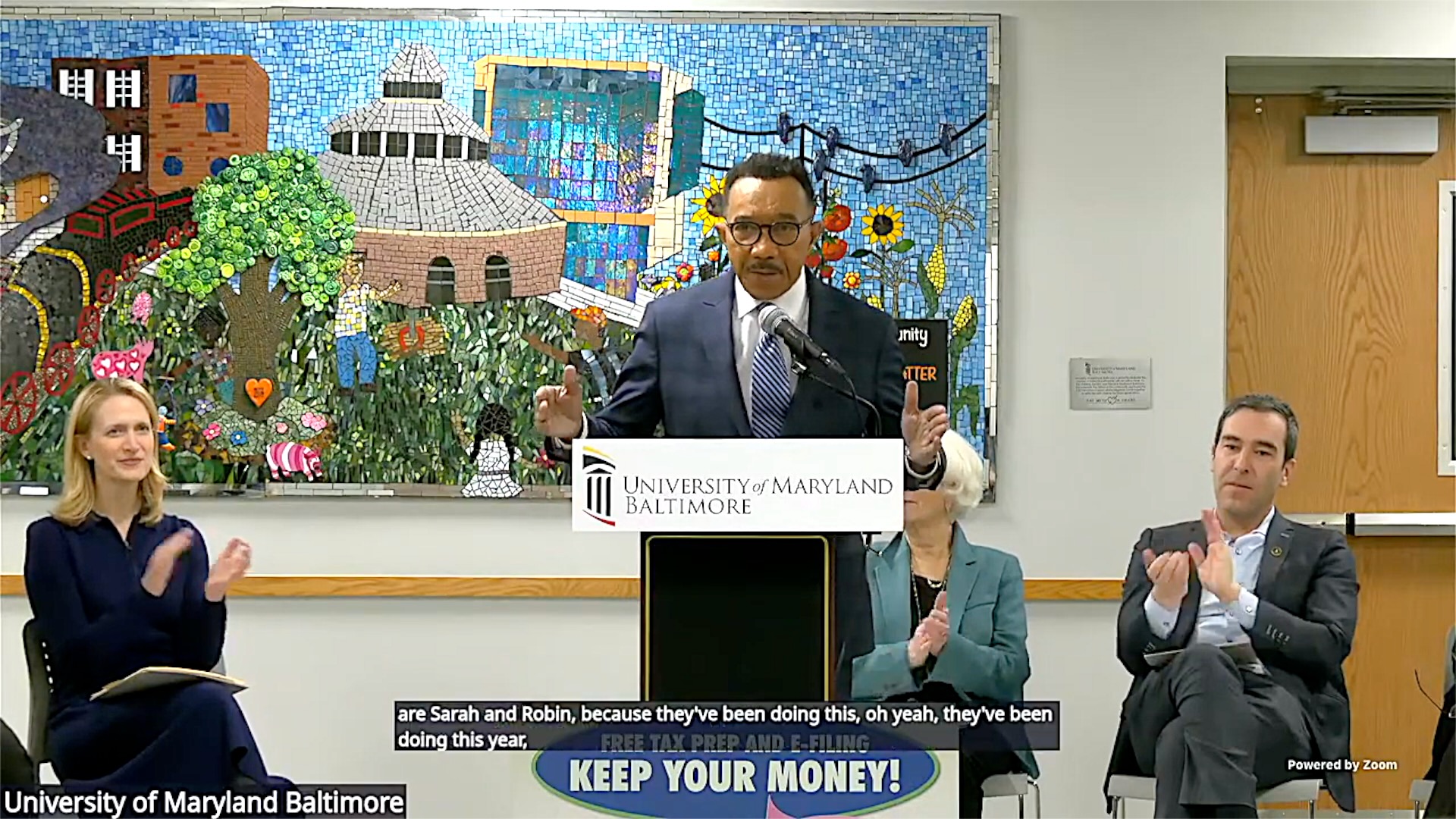 Rep. Kweisi Mfume speaks in support of the CASH Campaign of Maryland while MD Comptroller. Brooke Lierman and Baltimore City Council President Zeke Cohen applaud.