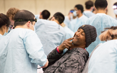 A patient describes pain caused by a decayed tooth as fourth year student Daniel DeCillis at the University of Maryland School of Dentistry listens.