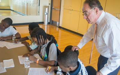 University of Maryland Baltimore President Jay A. Perman, MD, interacts with students during a summer camp held in partnership with Franklin Square Elementary/Middle School.