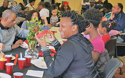 West Baltimore residents gather at a holiday luncheon held in the UMB Community Engagement Center in Poppleton on Dec. 23, 2016. 
