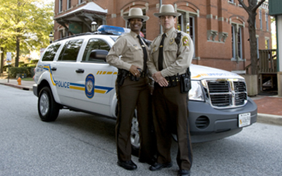 Two UMB officers with their SUV