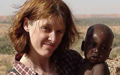 Doctor Lyke holding an african child