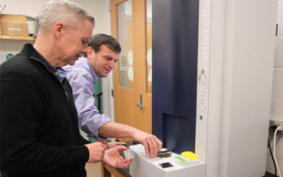 David Goodlett, PhD, and Robert Ernst, PhD, work in the Mass Spectrometry Center at the School of Pharmacy.