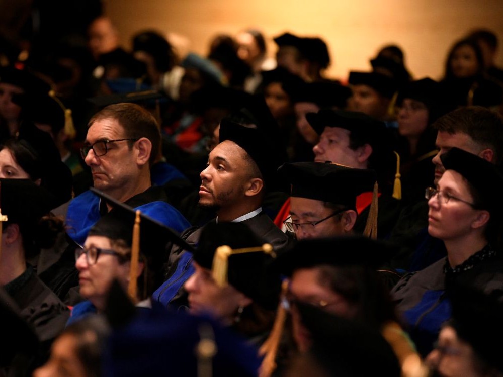 Attendees, including graduating students and faculty, during the 2025 Doctoral Hooding Ceremony.