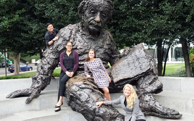 McMillan Ching, Dominique Earland, Jenny Breau, and Erin Teigen pose on the Einstein statue after receiving the grand prize at the sixth annual D.C. Public Health Case Challenge.