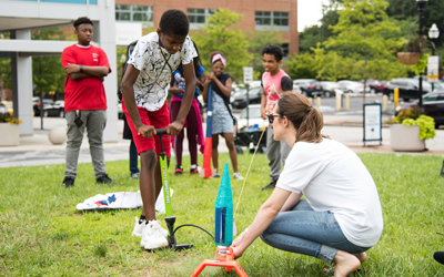 The CURE Scholars learn about gravity and the four forces of flight with a homemade bottle rocket experiment.