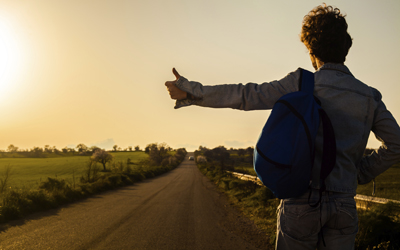 Rural youth is shown hitchhiking.