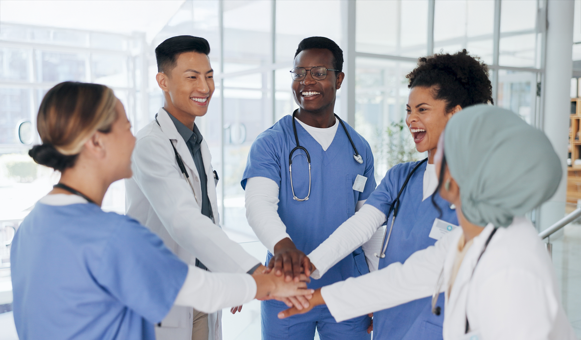 Doctors putting their hands in