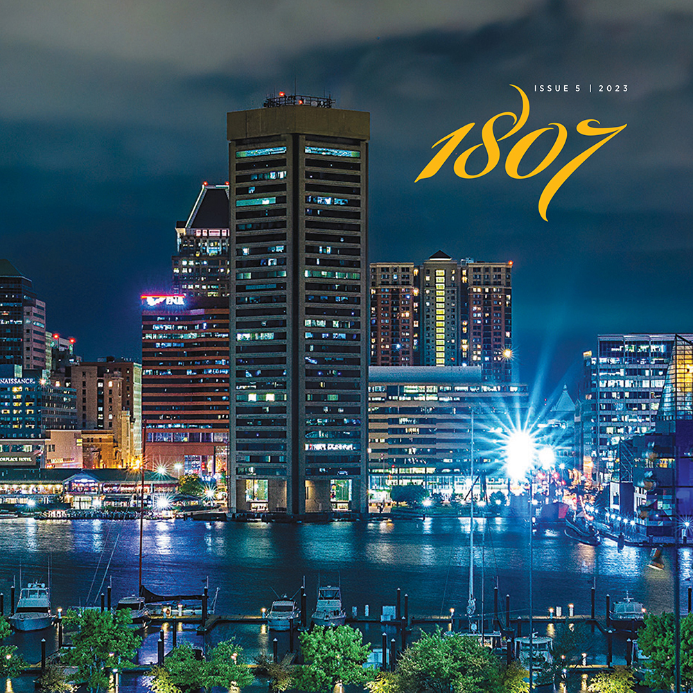 The cover of 1807 Issue 5. Features “Raining in Baltimore,” a photograph captured by 2012 University of Maryland School of Medicine alumnus Andrew C. Judd, MD. The photograph depicts the Baltimore Inner Harbor on a cloudy evening as a thunderstorm moves into the area.