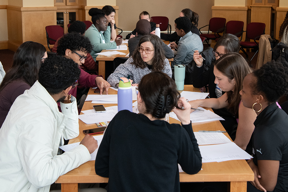 Students and Professor discussing at table