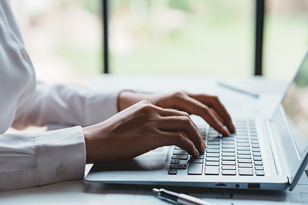A woman typing on a computer