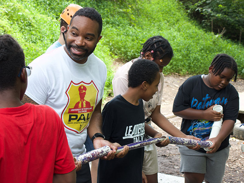 Lt. Matthew Johnson and PAL students take part in team-building activities at Terrapin Adventures in July 2025